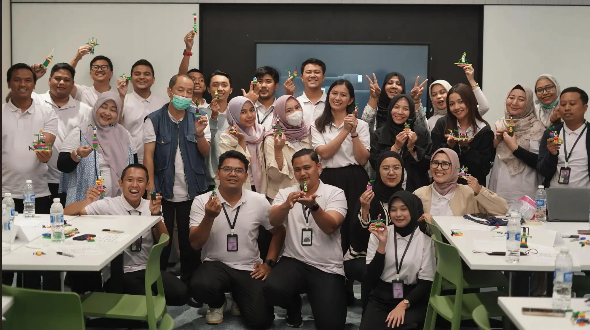 Workshop participants celebrating with their LEGO Serious Play builds